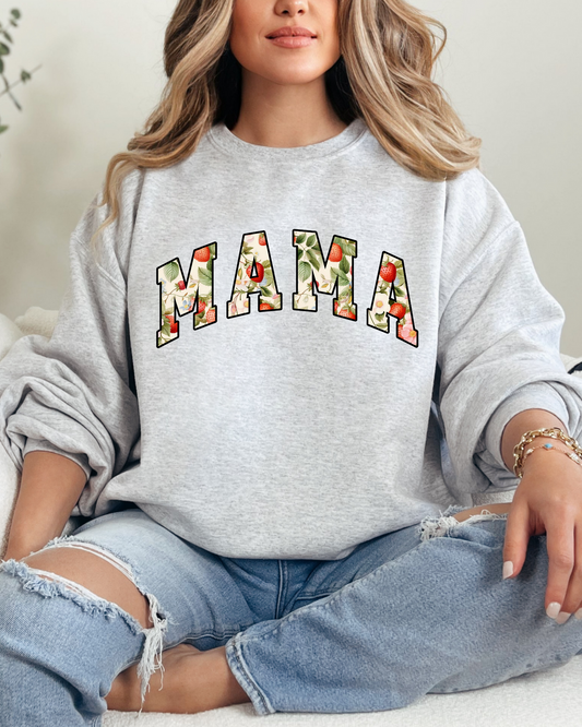 Person wearing a gray sweatshirt with 'MAMA' printed on it, sitting on a couch.