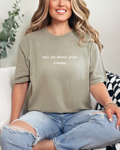 Person wearing a green t-shirt with text sitting on a couch.