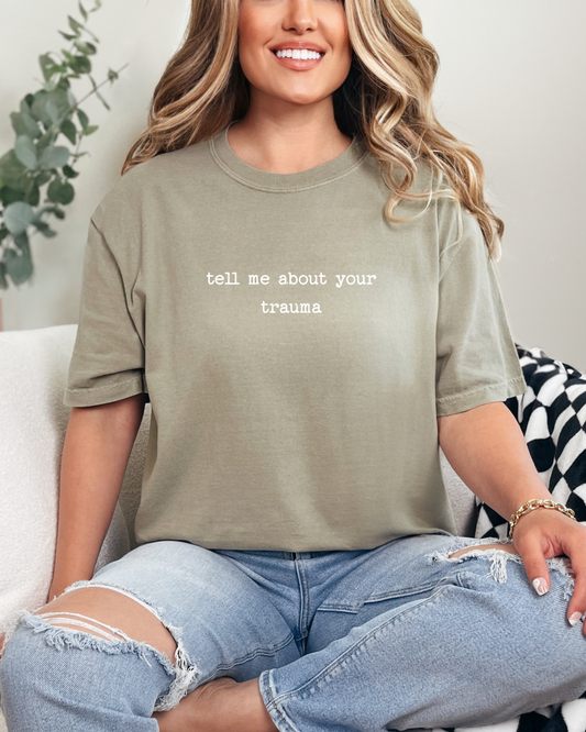 Person wearing a green t-shirt with text sitting on a couch.